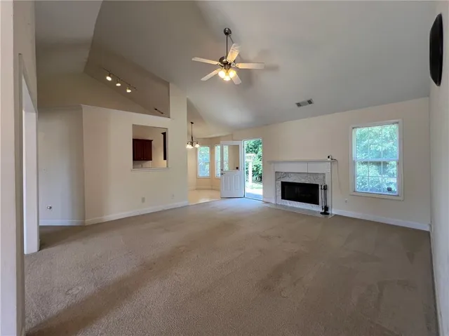 a spacious bathroom with a granite countertop sink a toilet and shower