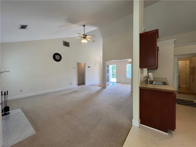 a kitchen with stainless steel appliances kitchen island granite countertop a refrigerator stove and oven