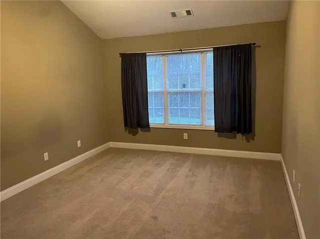 a spacious bathroom with a bathtub sink and mirror