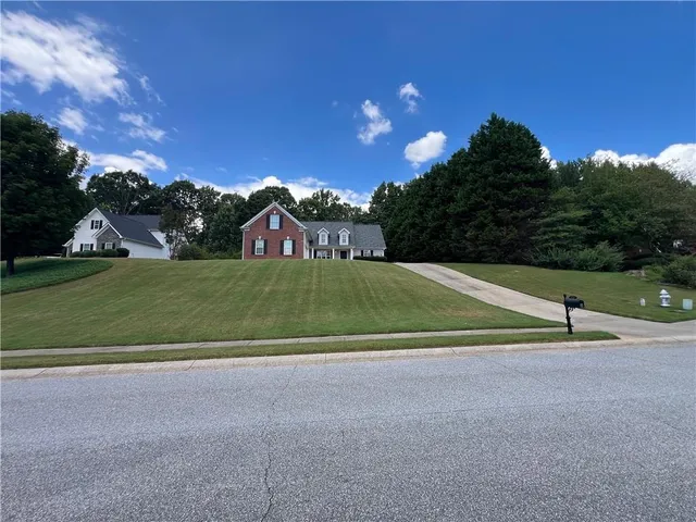 a front view of a house with a yard