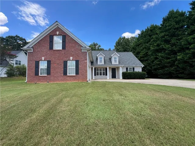 a view of a livingroom with furniture wooden floor and chandelier