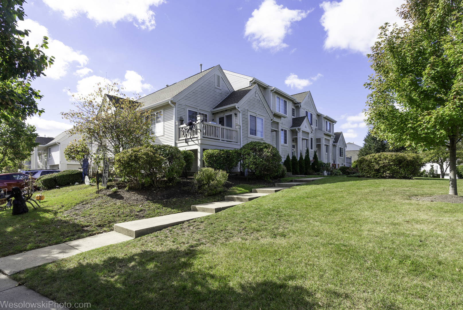 644 South Rosehall Lane, Unit 644 Round Lake, IL 60073 - Photo 30 of 33 a front view of a house with a yard and trees