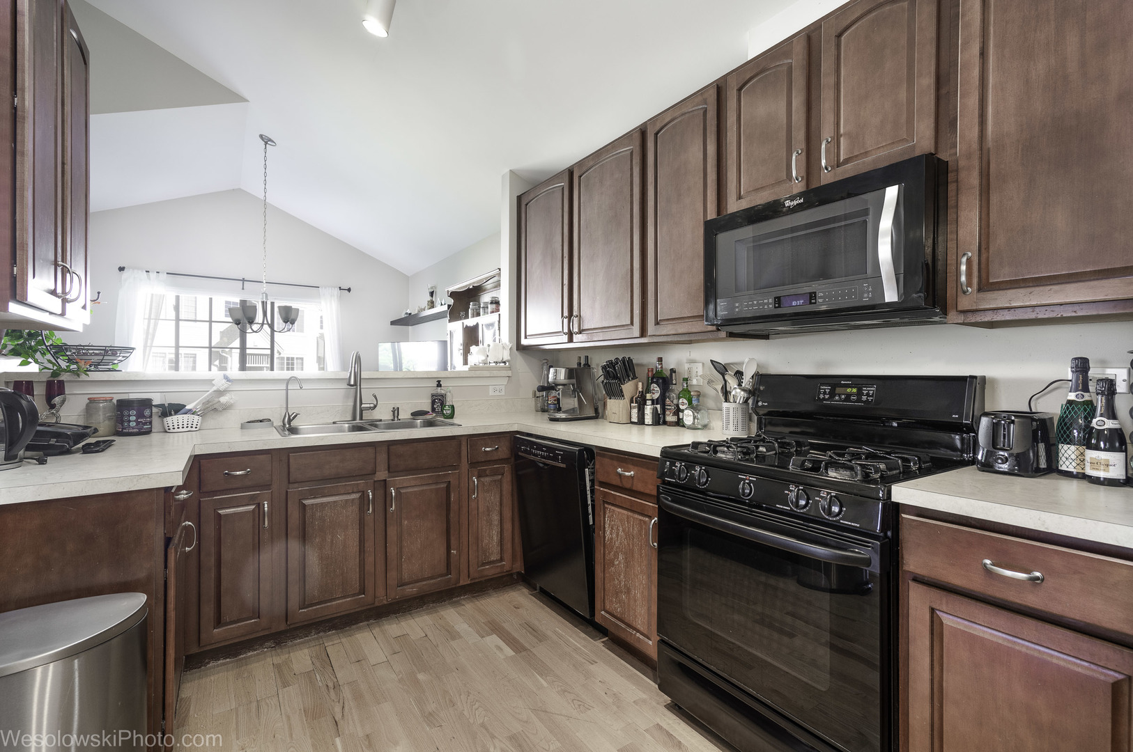 644 South Rosehall Lane, Unit 644 Round Lake, IL 60073 - Photo 10 of 33 a kitchen with stainless steel appliances granite countertop wooden cabinets stove top oven and sink