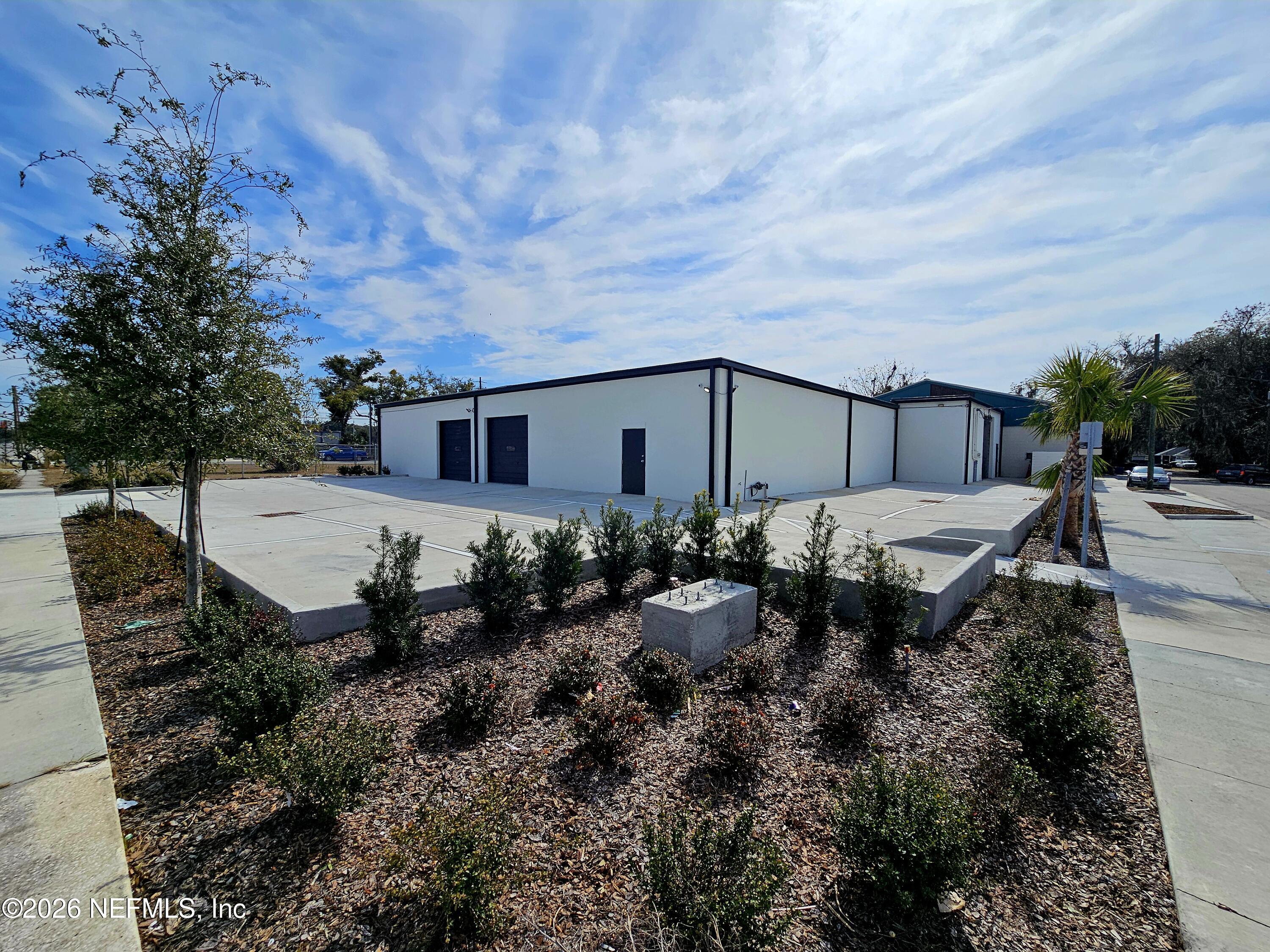 a backyard of a house with table and chairs