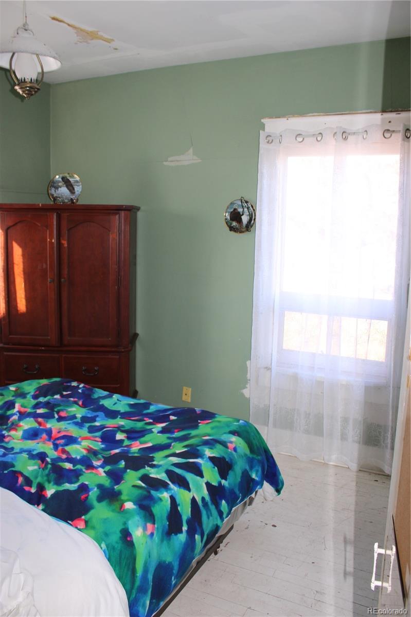 1901 County Road East Joes, CO 80822 - Photo 34 of 42 a bedroom with a bed and a table in it