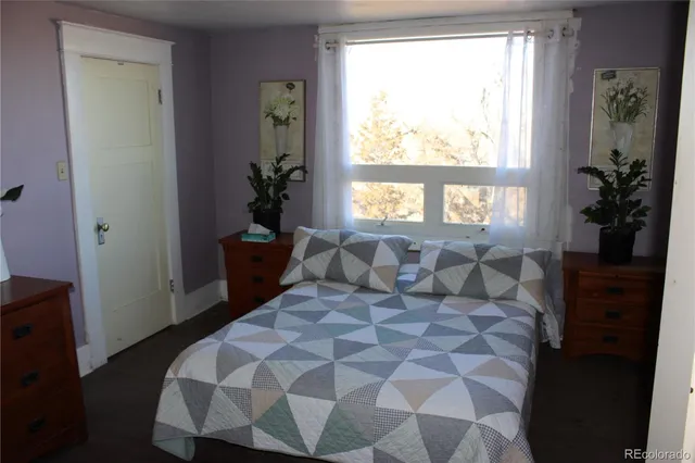 a living room with furniture a rug and a window