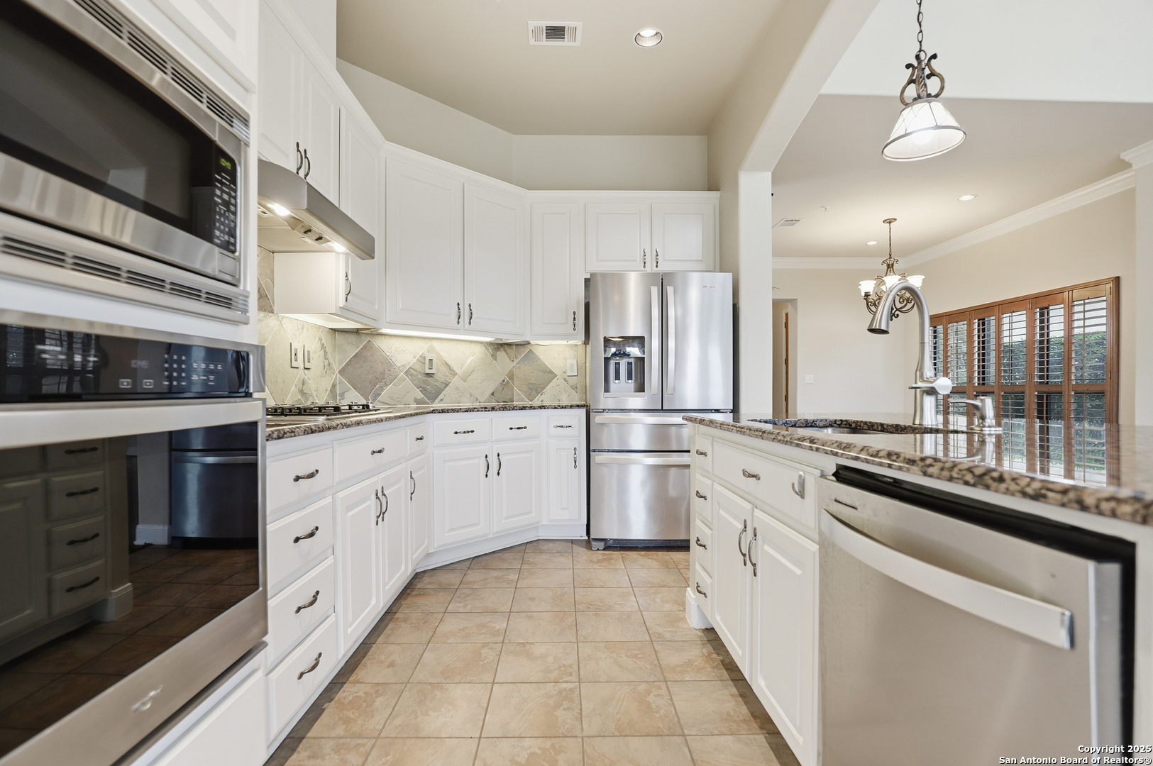 7800 Sw Parkway, Unit 1710 Austin, TX 78735 - Photo 11 of 34 a kitchen that has a lot of white cabinets and stainless steel appliances