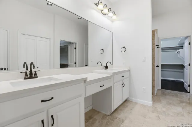 a spacious bathroom with a double vanity sink mirror and double