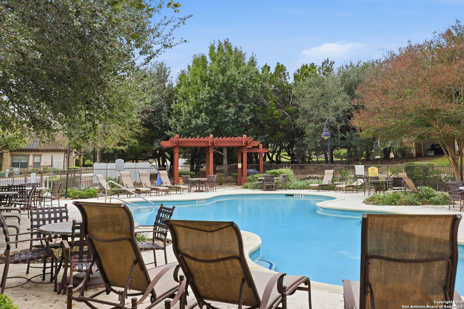 7800 Sw Parkway, Unit 1710 Austin, TX 78735 - Photo 33 of 34 a view of a swimming pool with outdoor seating and a forest
