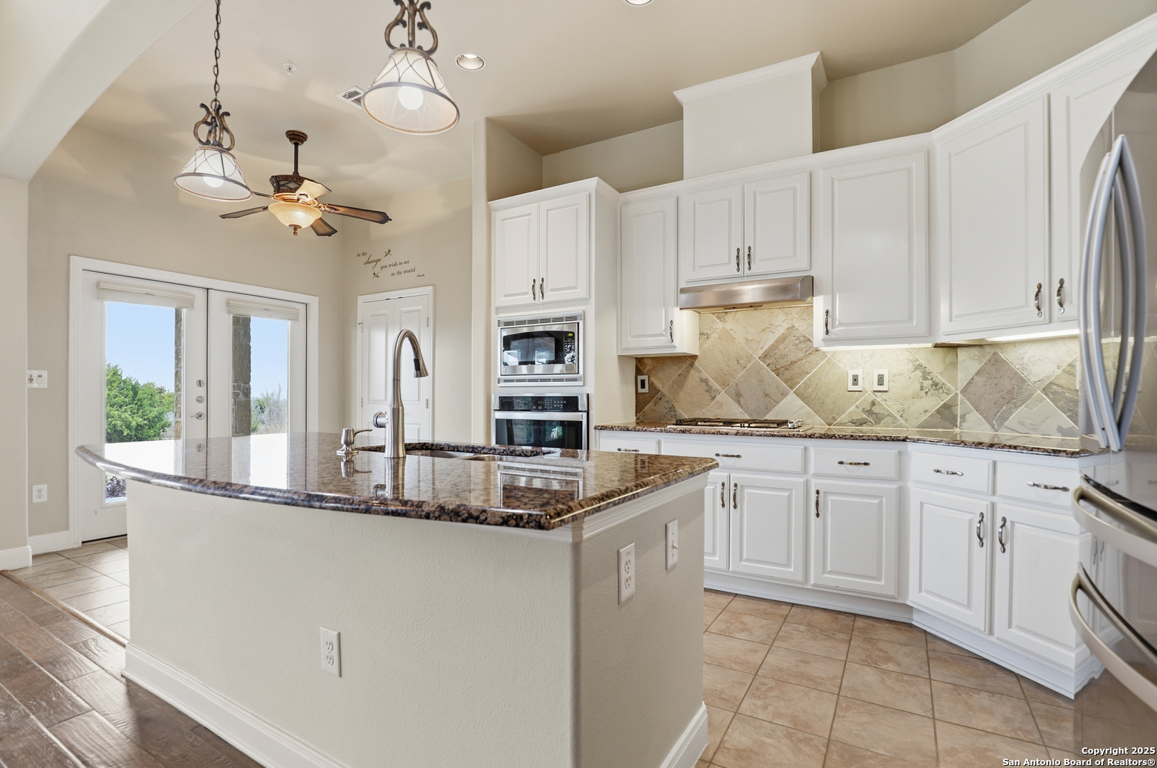 7800 Sw Parkway, Unit 1710 Austin, TX 78735 - Photo 10 of 34 a kitchen with kitchen island granite countertop white cabinets white stainless steel appliances with a sink and dishwasher