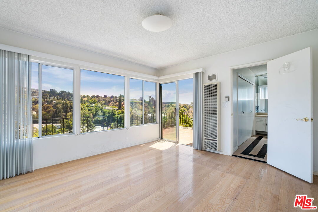 1460 Carla Ridge Beverly Hills, CA 90210 - Photo 15 of 20 a view of empty room with floor to ceiling window