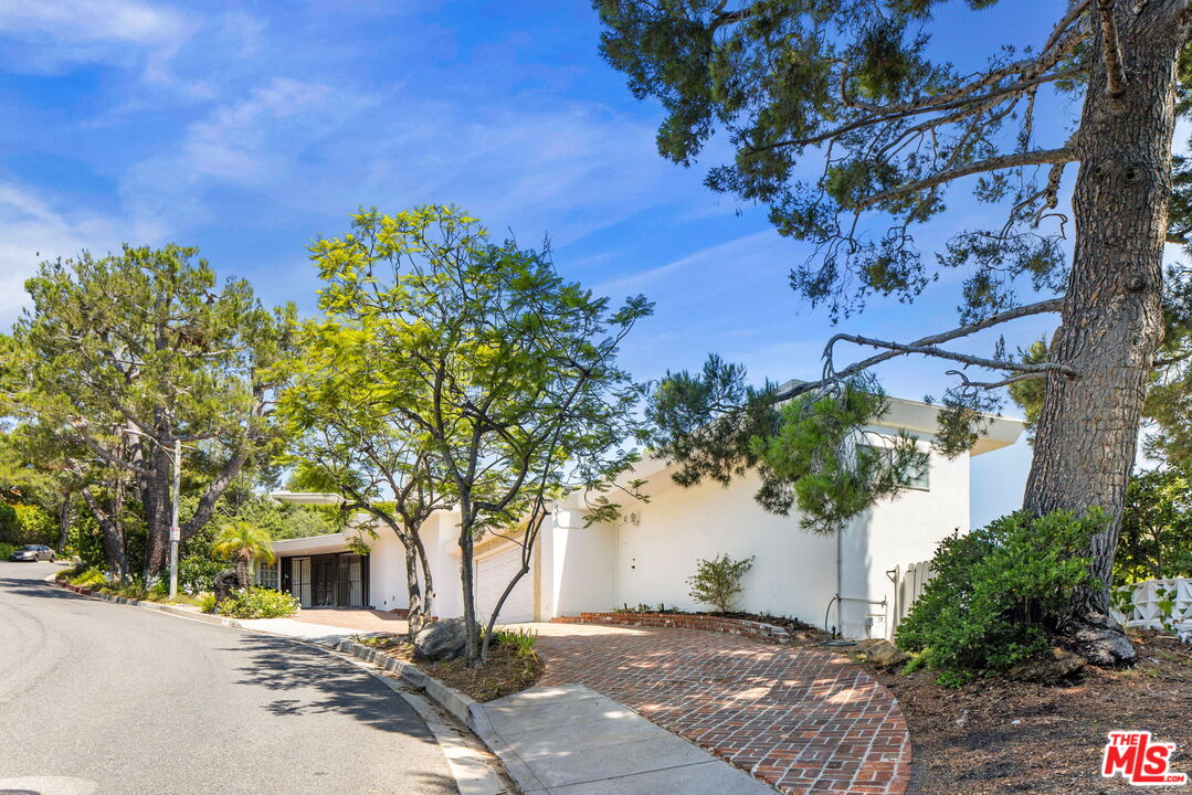 1460 Carla Ridge Beverly Hills, CA 90210 - Photo 2 of 20 a front view of a house with a tree