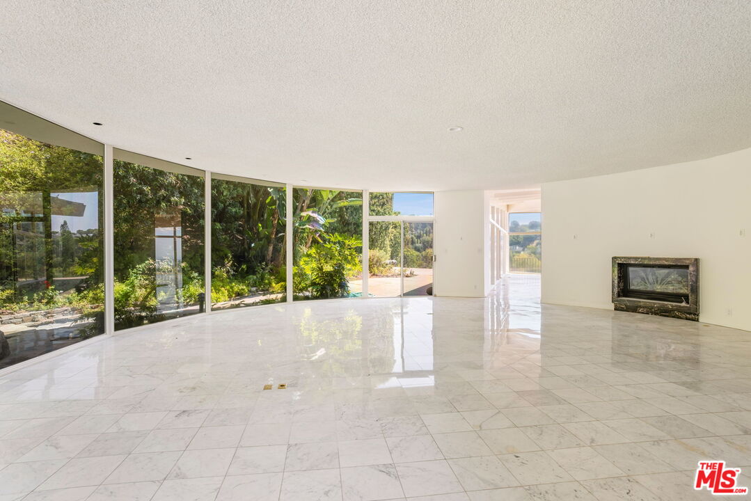 1460 Carla Ridge Beverly Hills, CA 90210 - Photo 9 of 20 a view of an empty room with windows