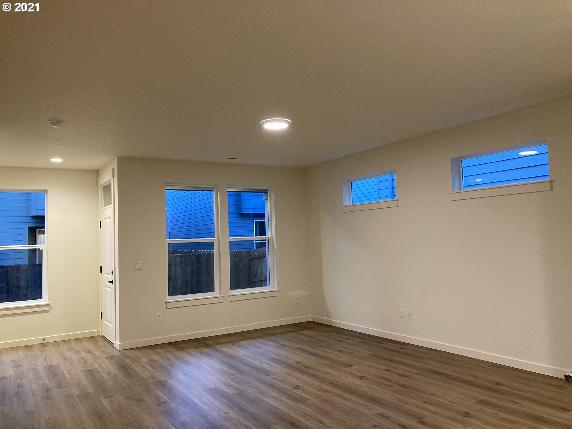 7024 South 13th Street Ridgefield, WA 98642 - Photo 5 of 13 a view of an empty room with wooden floor and a window