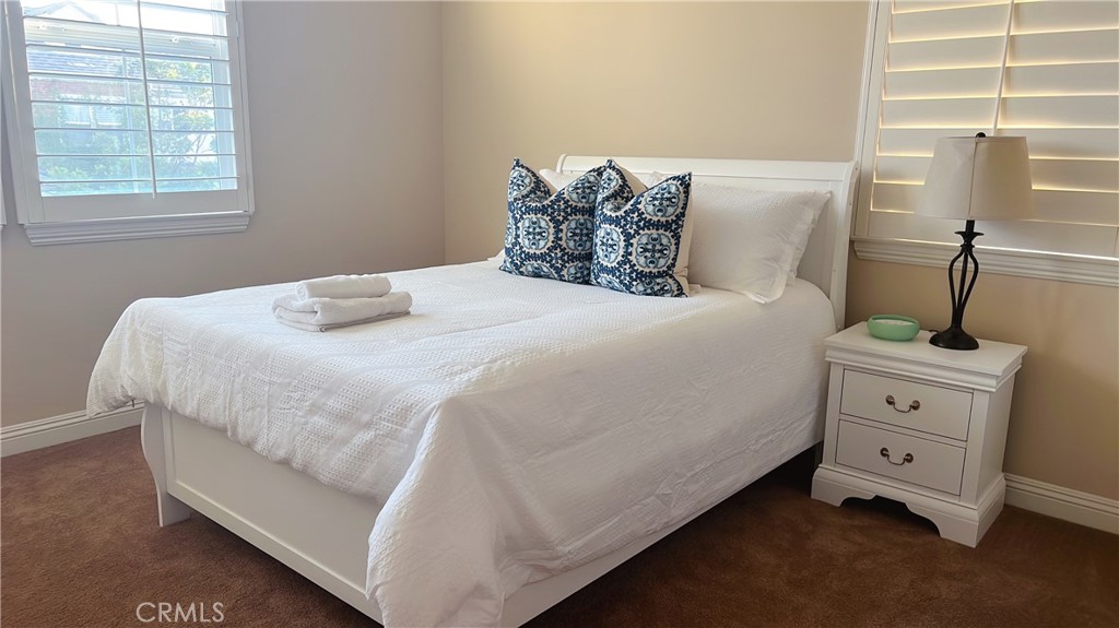 109 Sideways Irvine, CA 92618 - Photo 8 of 12 a bedroom with a bed and window