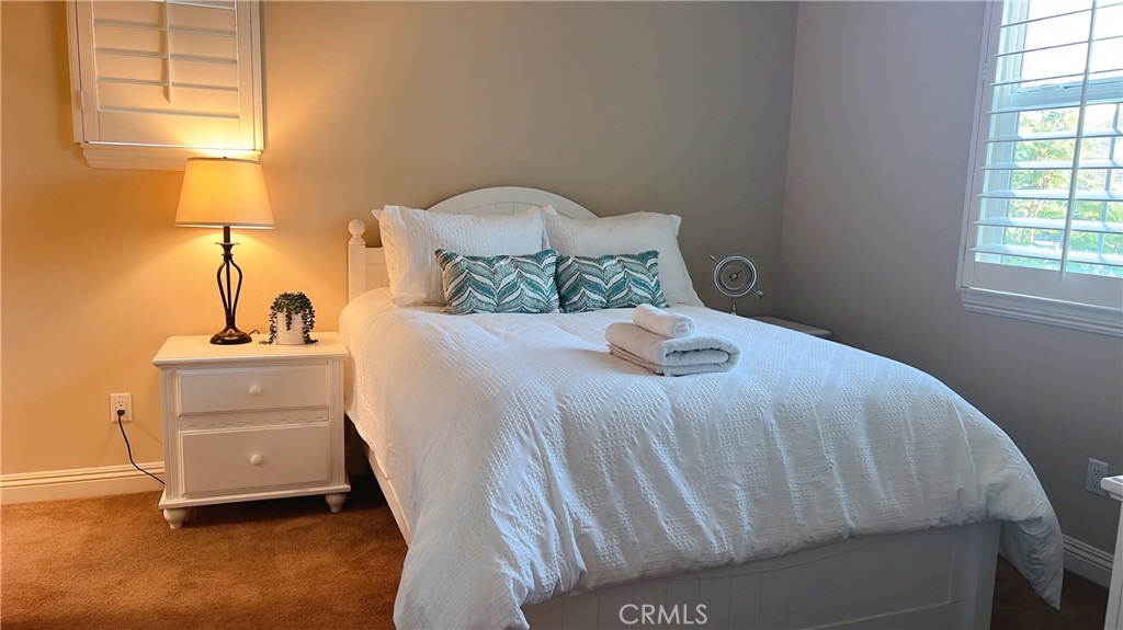 109 Sideways Irvine, CA 92618 - Photo 9 of 12 a bedroom with a bed and a window