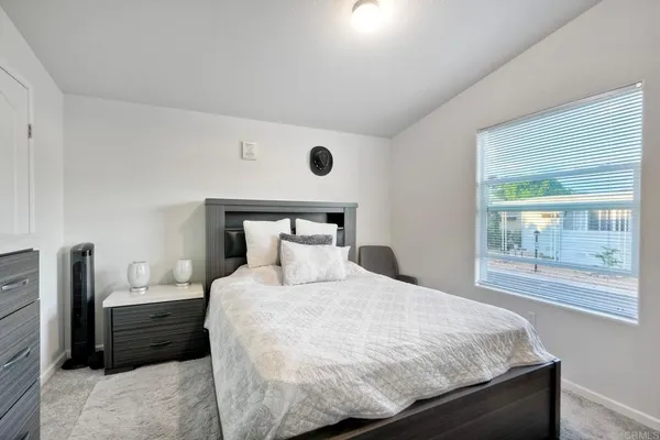 a bedroom with a bed and window