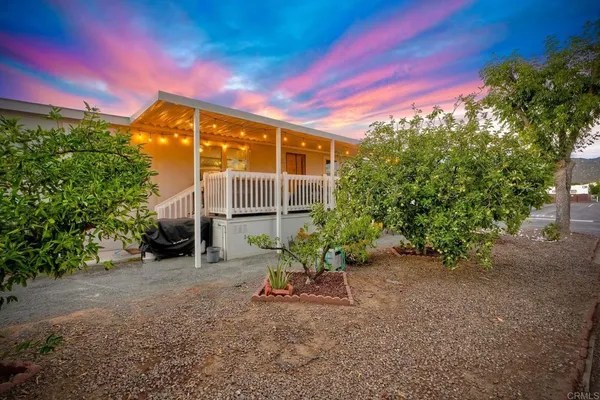 a backyard of a house with table and chairs