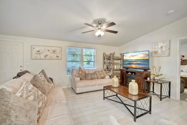 a living room with furniture a rug and a window