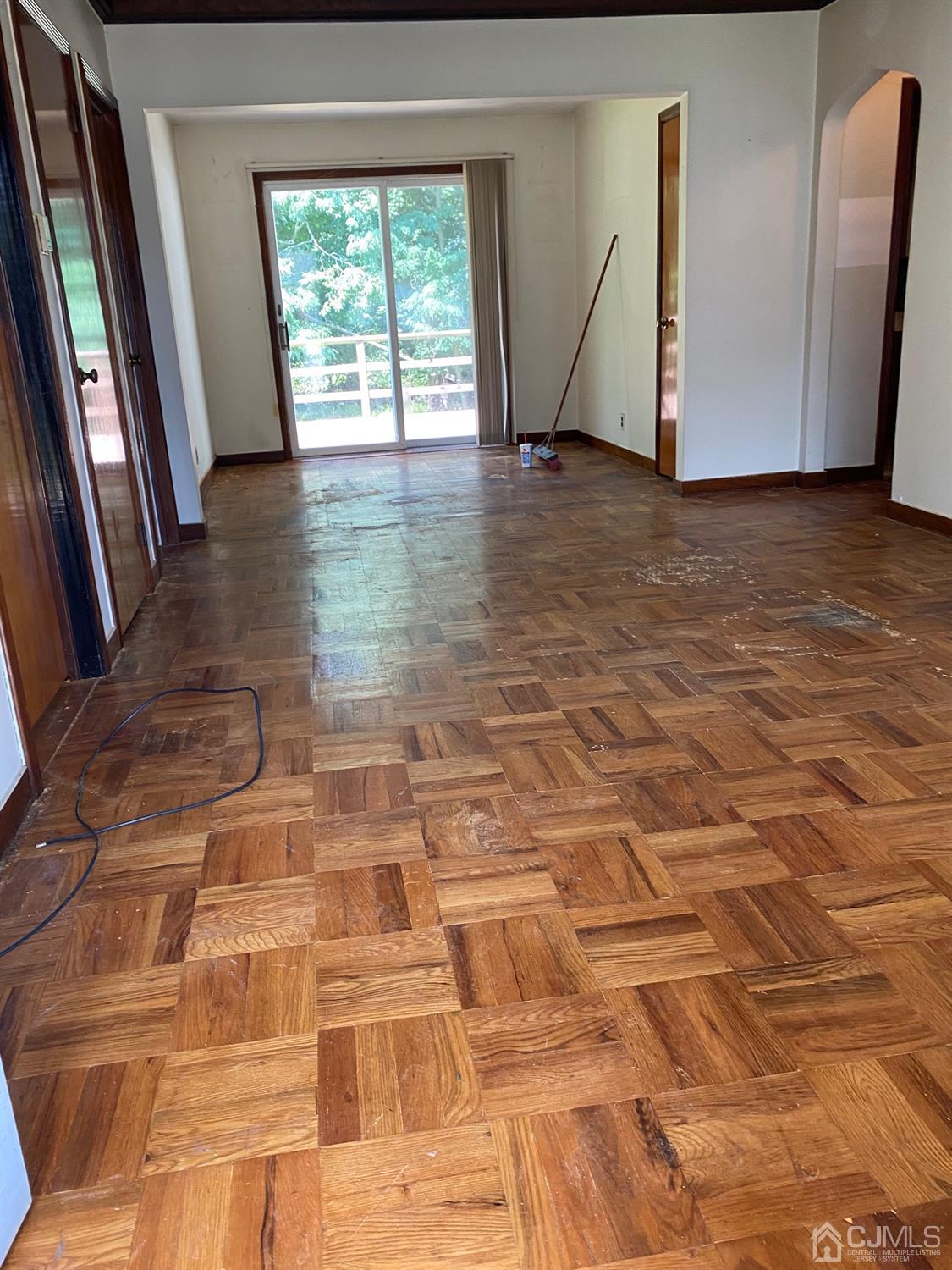 604 Mountain View Terrace Middlesex, NJ 08846 - Photo 4 of 6 a view of an empty room with wooden floor and a window
