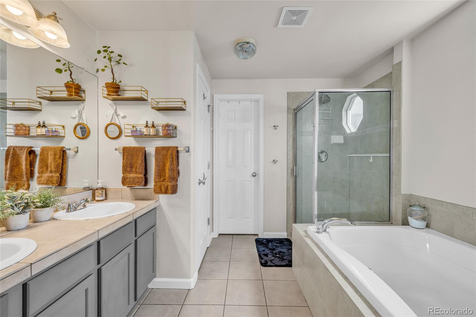 6132 Graden Street Frederick, CO 80530 - Photo 12 of 28 a spacious bathroom with a tub sink and mirror