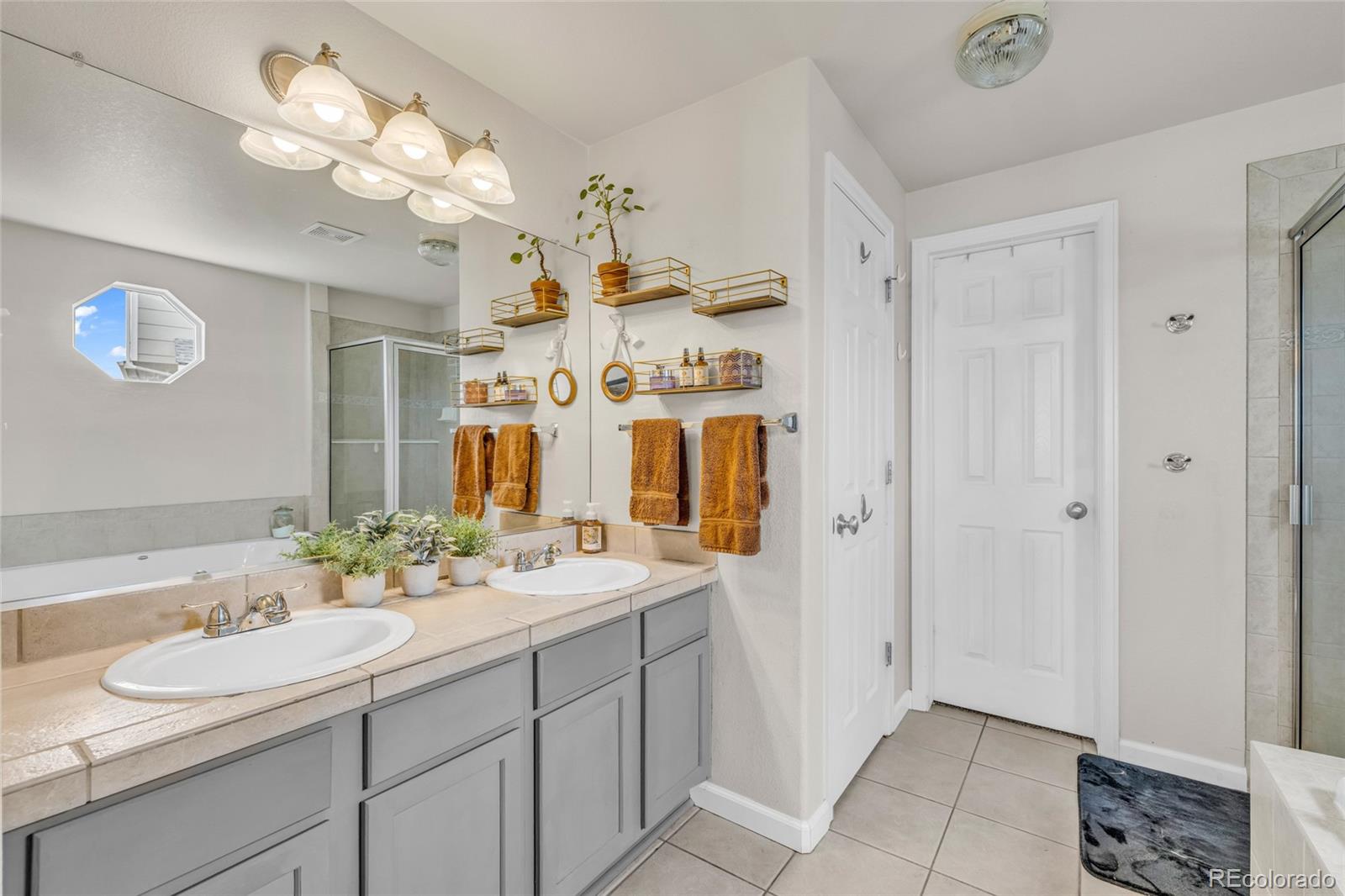 6132 Graden Street Frederick, CO 80530 - Photo 13 of 28 a bathroom with a sink vanity and a mirror