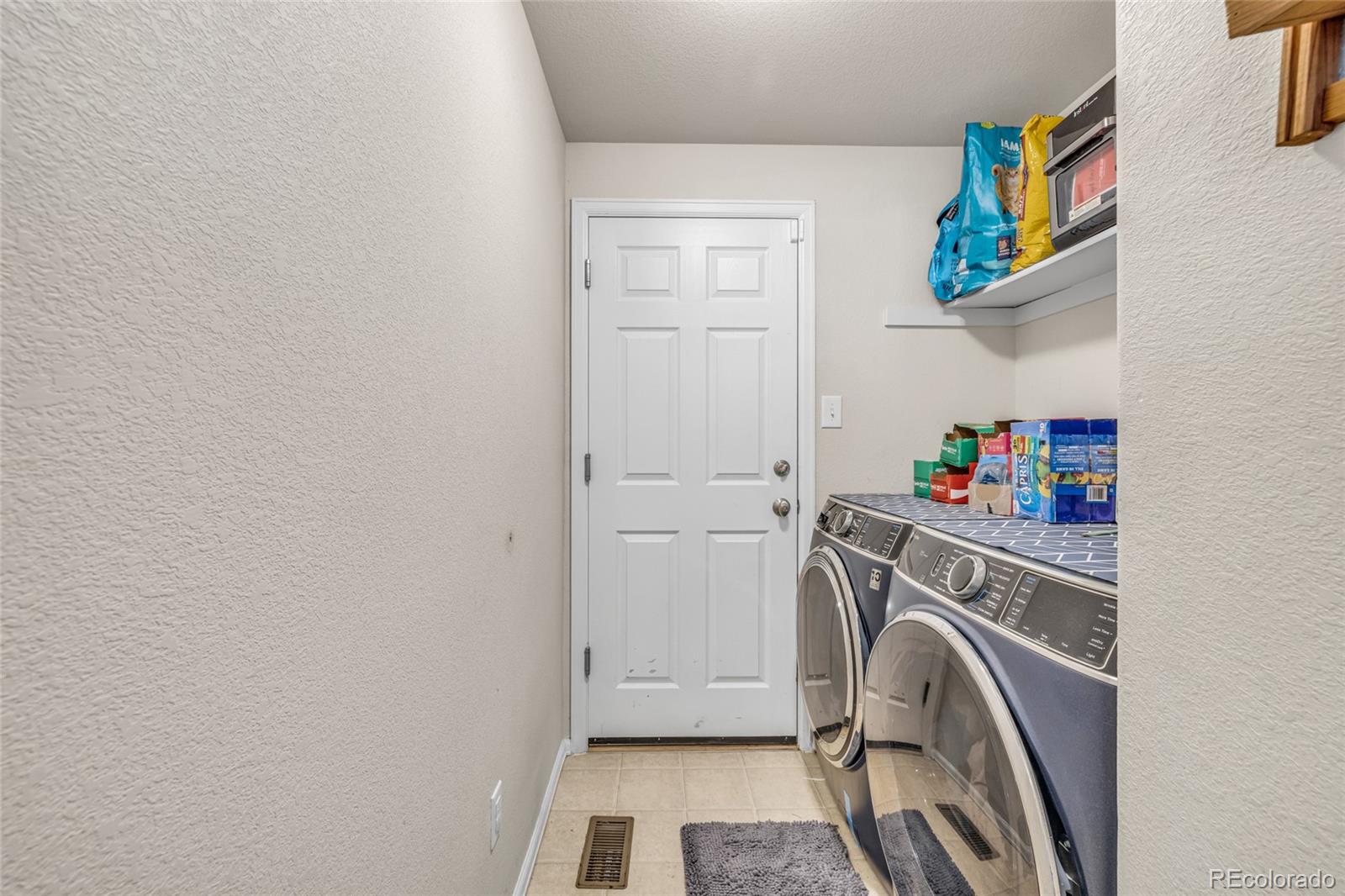 6132 Graden Street Frederick, CO 80530 - Photo 14 of 28 a utility room with dryer and washer