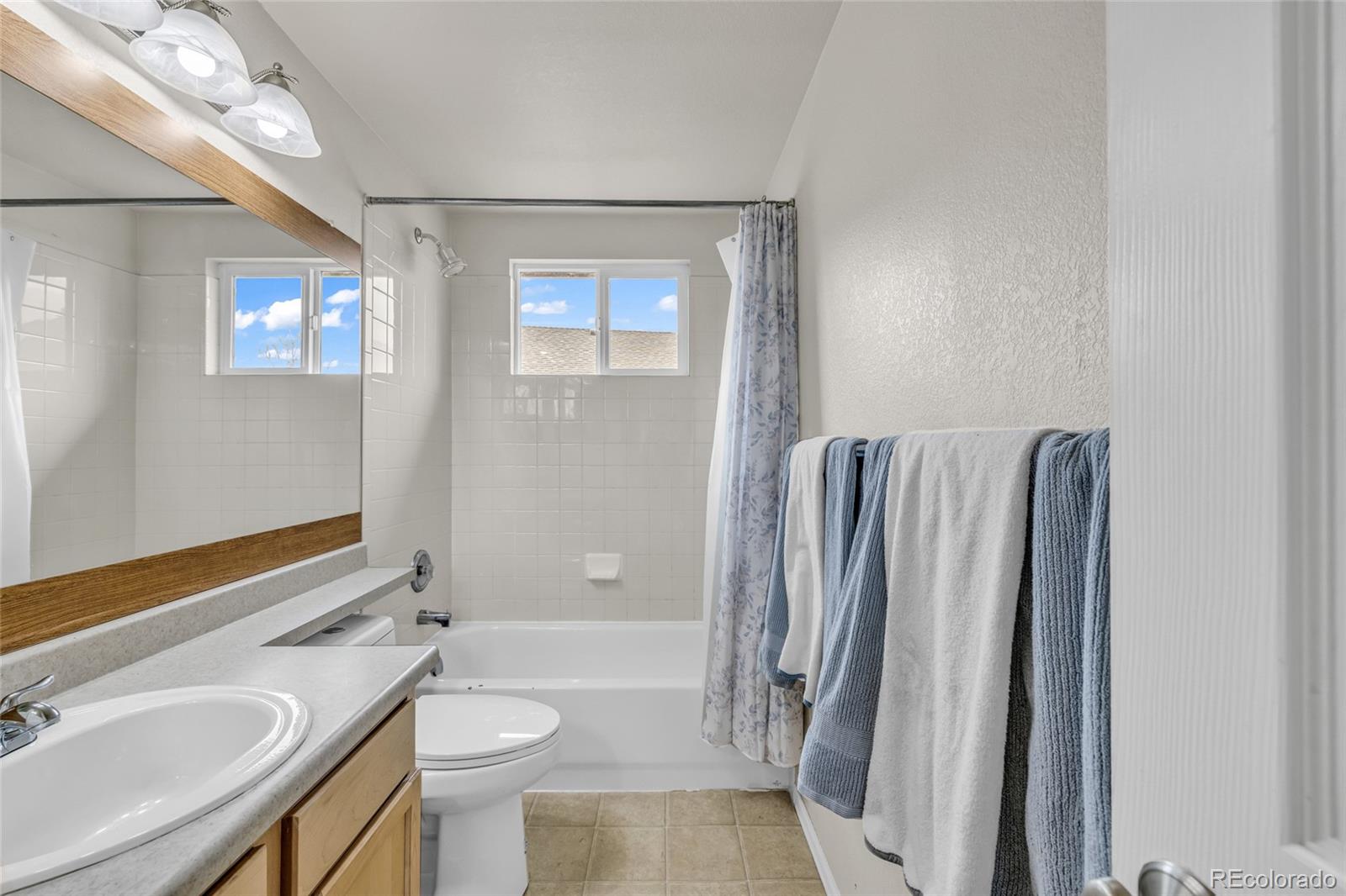 6132 Graden Street Frederick, CO 80530 - Photo 21 of 28 a bathroom with a sink a toilet and shower