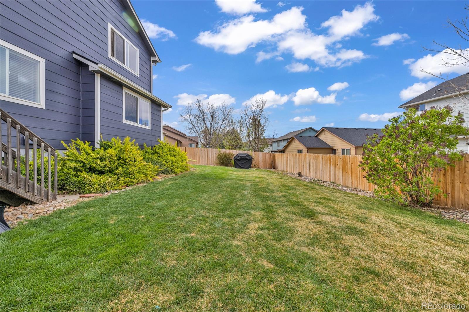 6132 Graden Street Frederick, CO 80530 - Photo 25 of 28 a front view of a house with garden