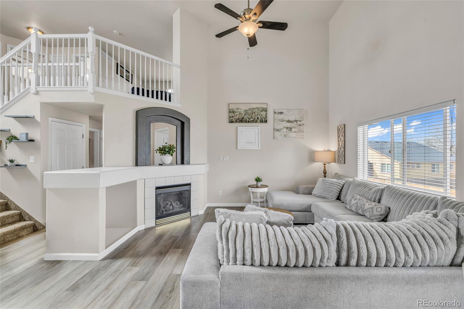 6132 Graden Street Frederick, CO 80530 - Photo 5 of 28 a living room with furniture a fireplace and a window