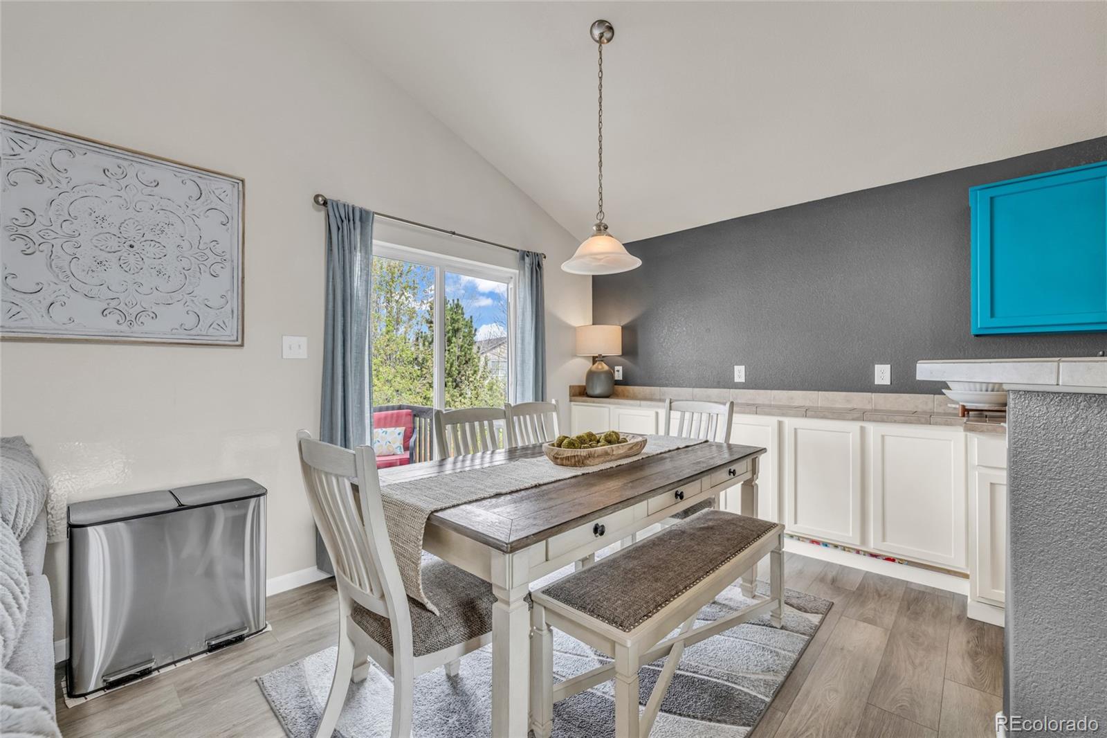 6132 Graden Street Frederick, CO 80530 - Photo 7 of 28 a view of a dining room with furniture window and wooden floor