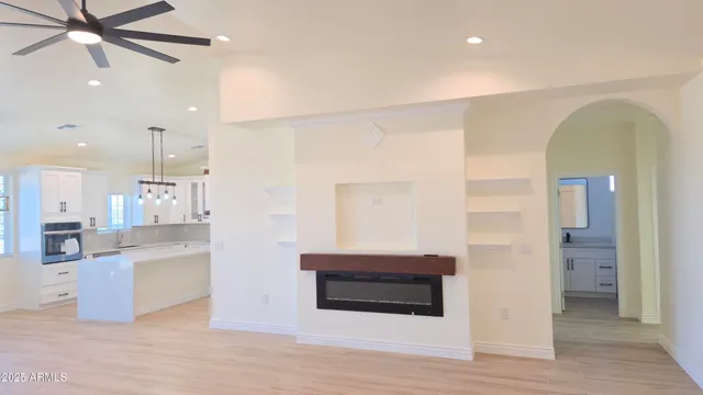 a living room with stainless steel appliances kitchen island granite countertop furniture and a kitchen view