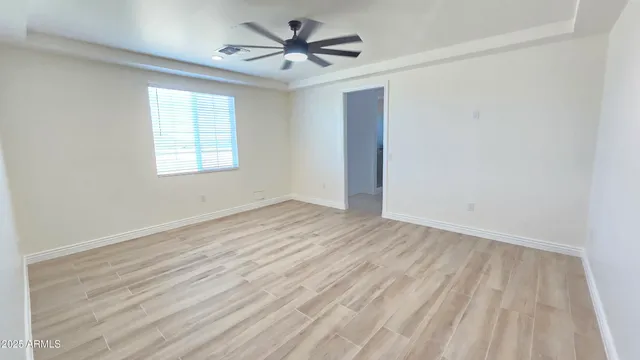 wooden floor in an empty room with a window