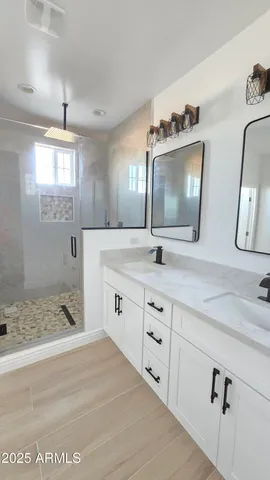 a bathroom with double sink and a mirror