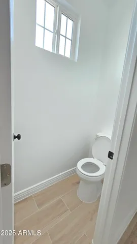 a white toilet sitting next to a shower