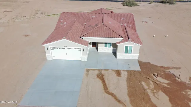 a view of a house with a yard and mountain