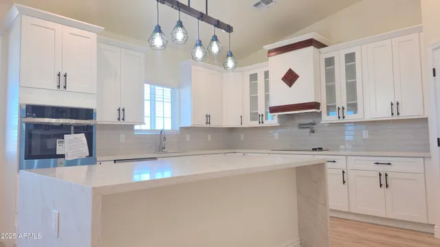 a kitchen with stainless steel appliances granite countertop a sink a stove and a refrigerator