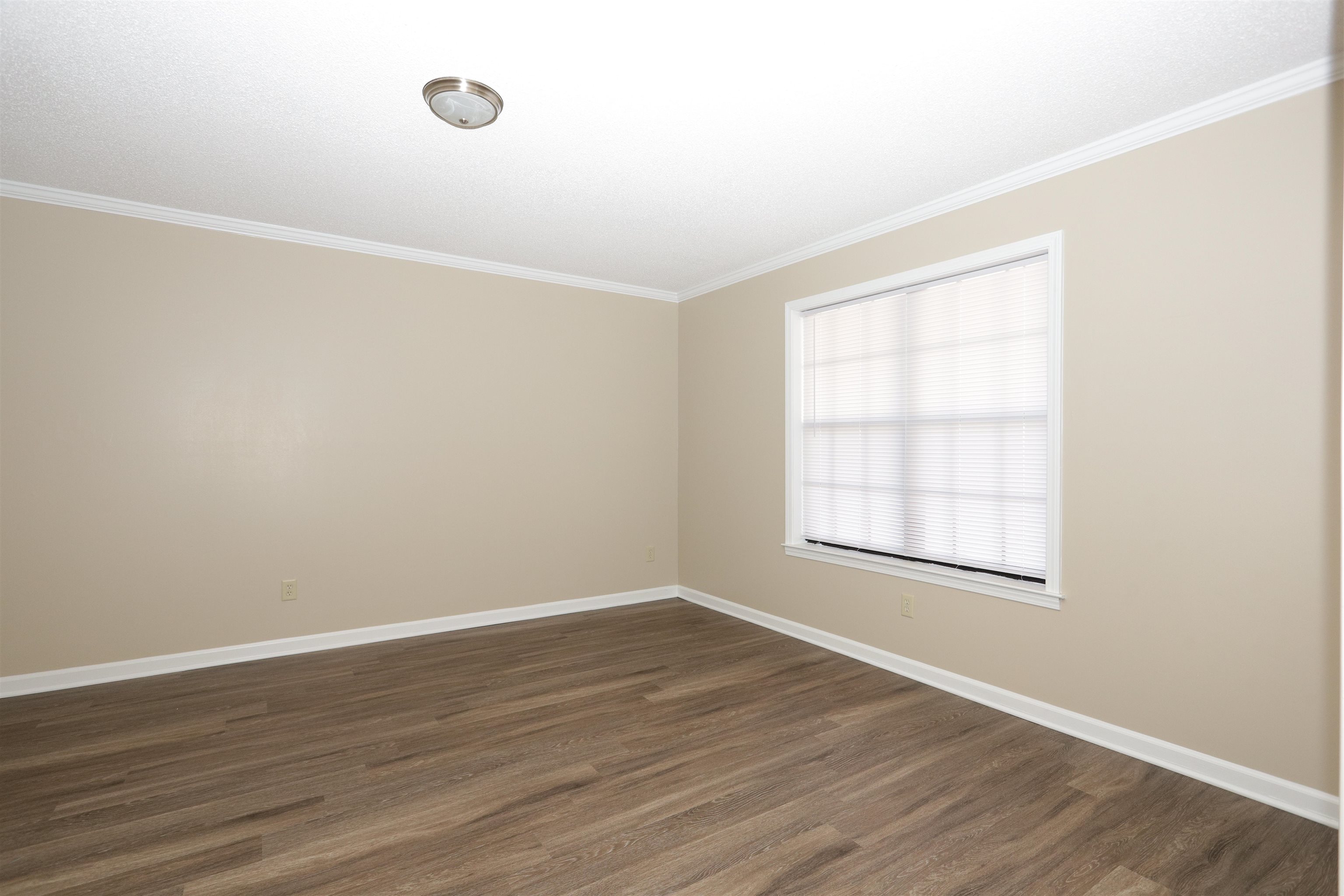 3164 Raleigh Ridge Drive Memphis, TN 38128 - Photo 4 of 15 an empty room with wooden floor and windows