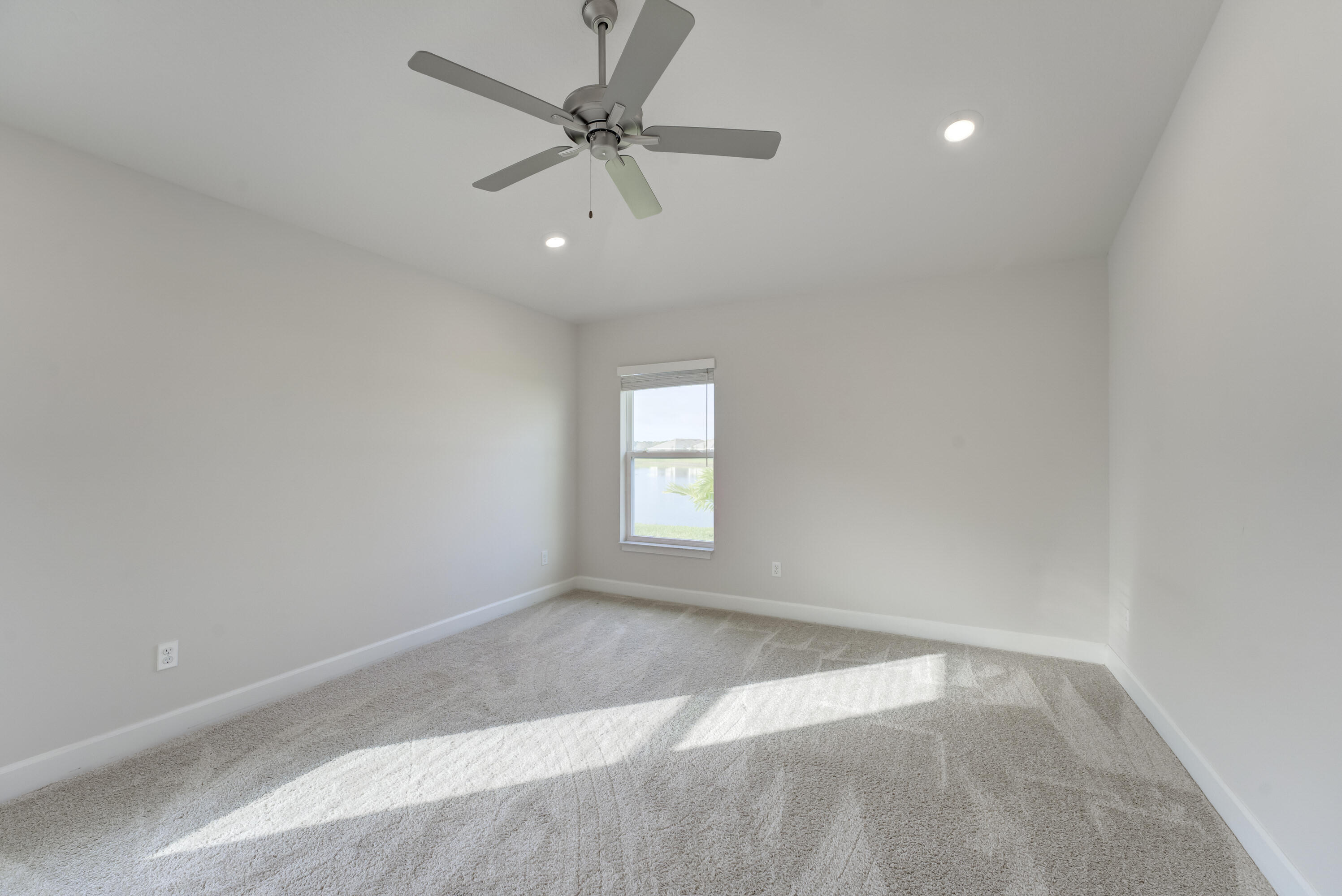 5327 Vespera Street Fort Pierce, FL 34951 - Photo 12 of 27 wooden floor in an empty room with a window