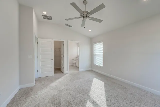 an empty room with fan and windows