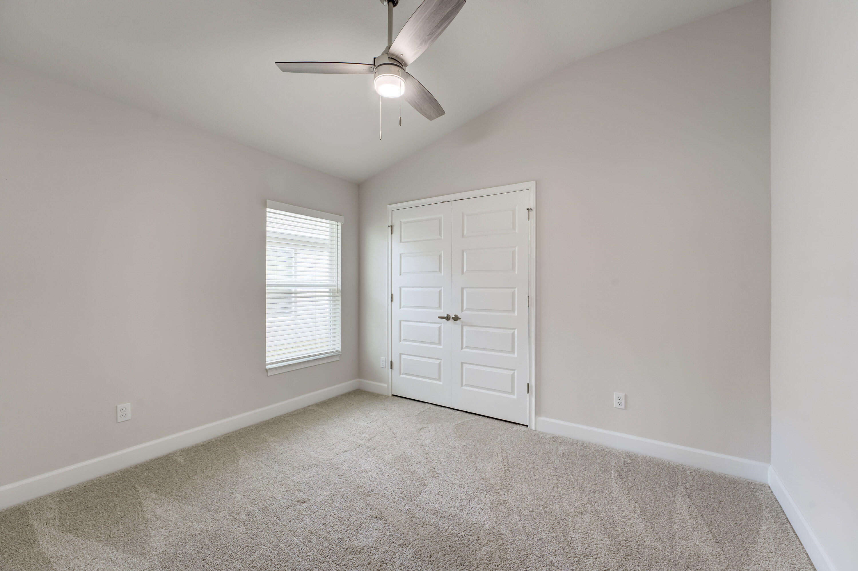 5327 Vespera Street Fort Pierce, FL 34951 - Photo 17 of 27 an empty room with windows and fan