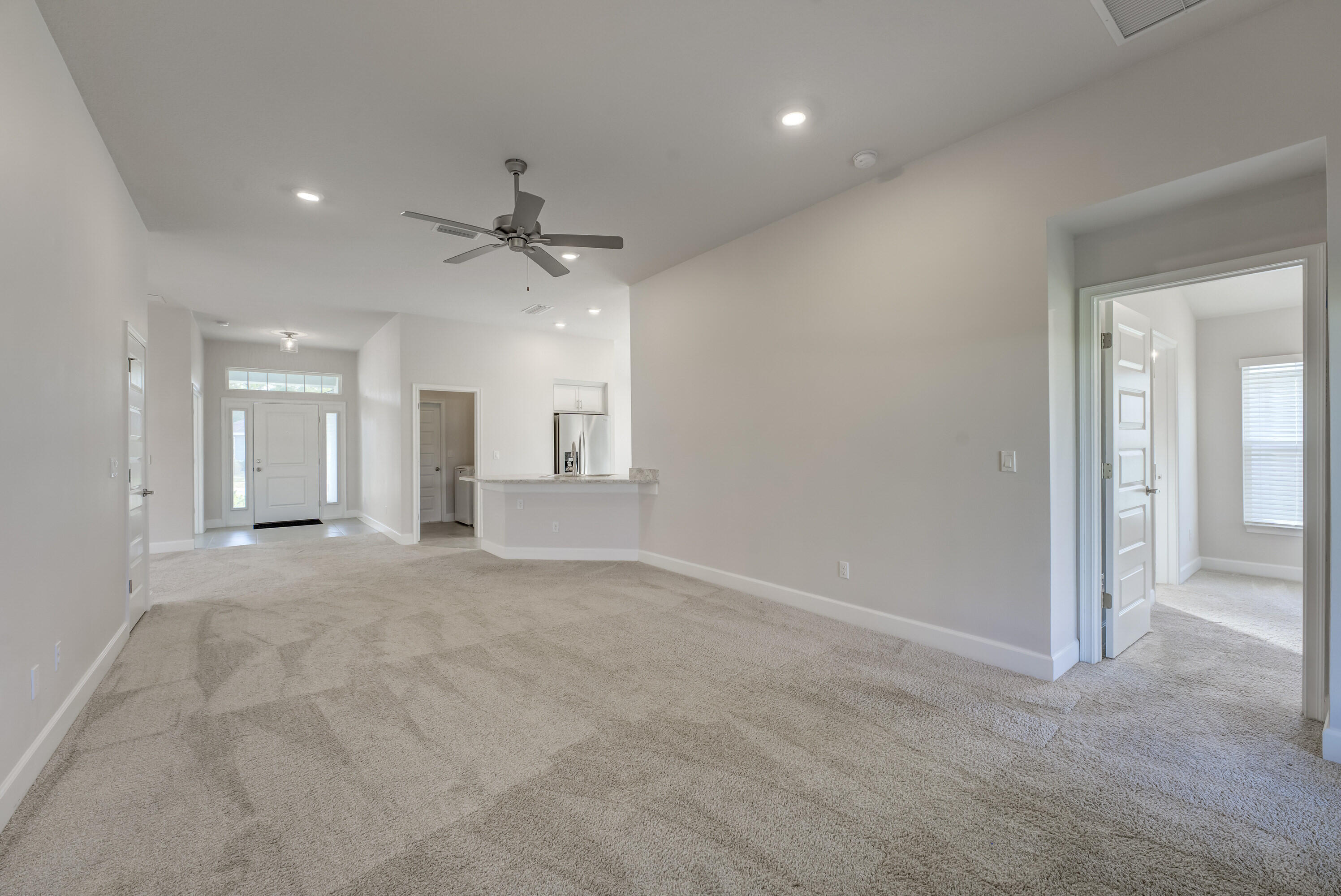 5327 Vespera Street Fort Pierce, FL 34951 - Photo 7 of 27 an empty room with fan and windows