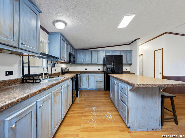 135 Savannah Ridge Von Ormy, TX 78073 - Photo 30 of 45 a large kitchen with stainless steel appliances granite countertop a stove a sink dishwasher a microwave oven and a refrigerator
