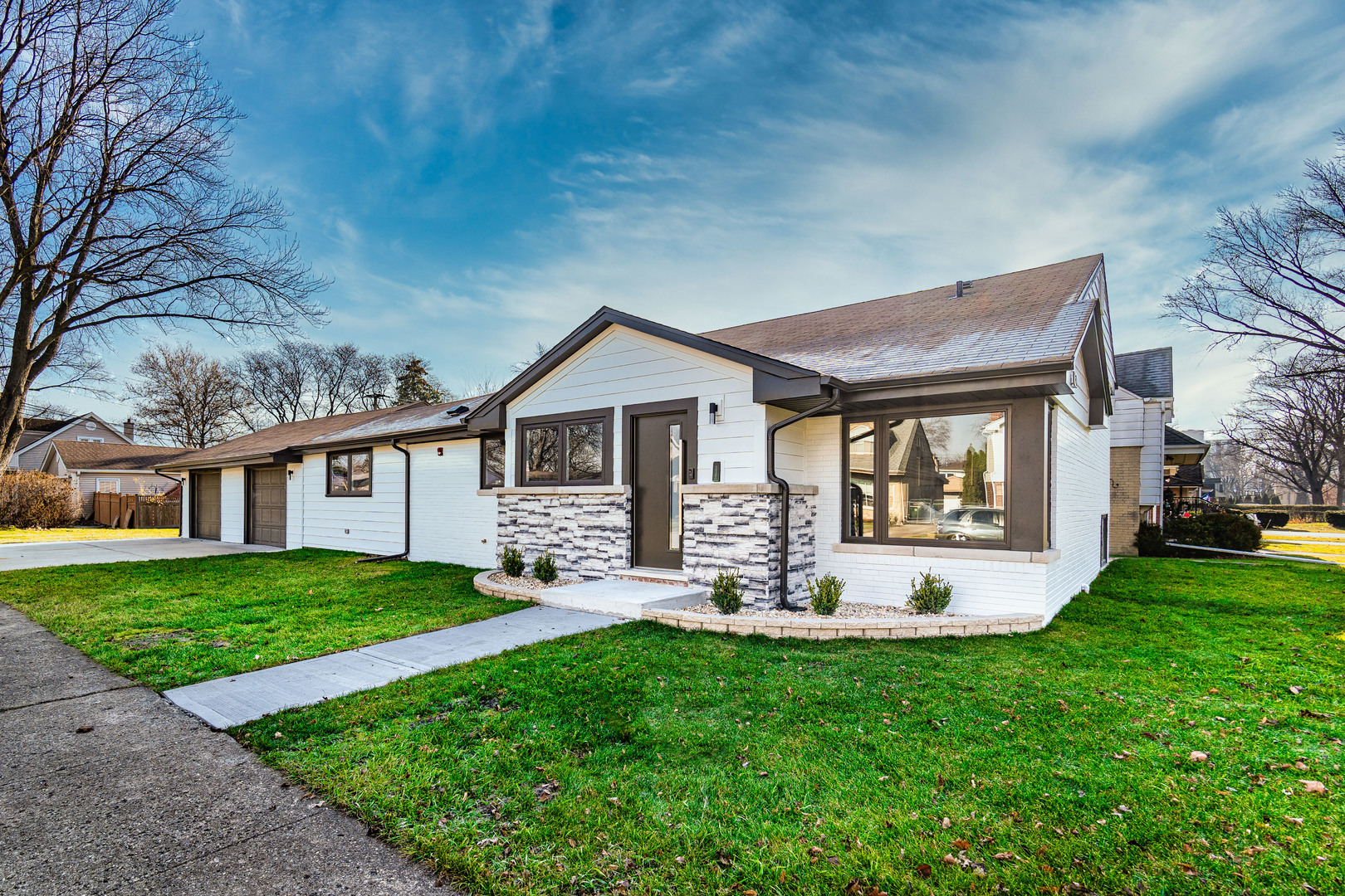 a front view of house with yard and green space