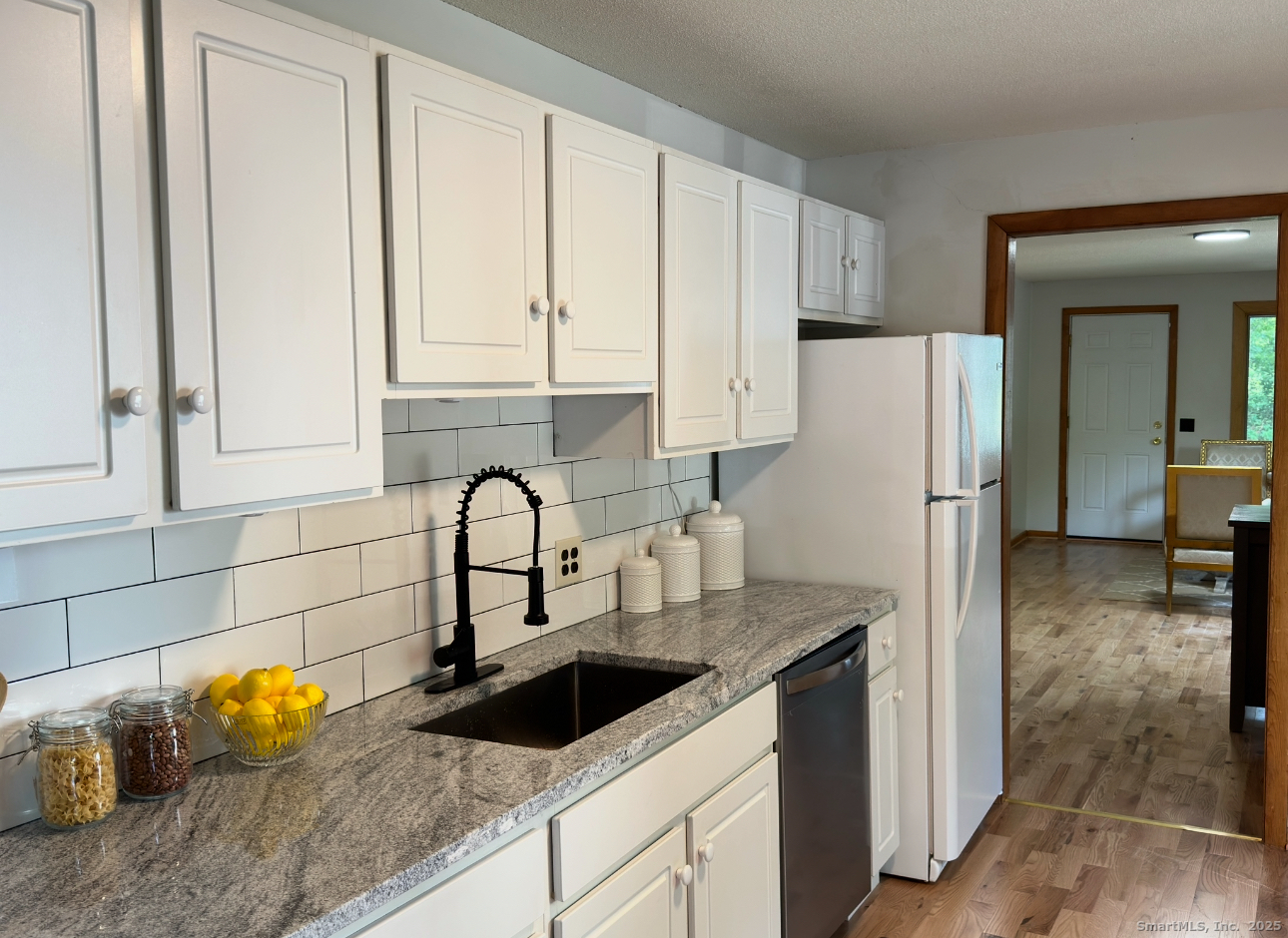 64 White Deer Rocks Road, Unit 5E Woodbury, CT 06798 - Photo 3 of 9 a kitchen with granite countertop a refrigerator and a sink