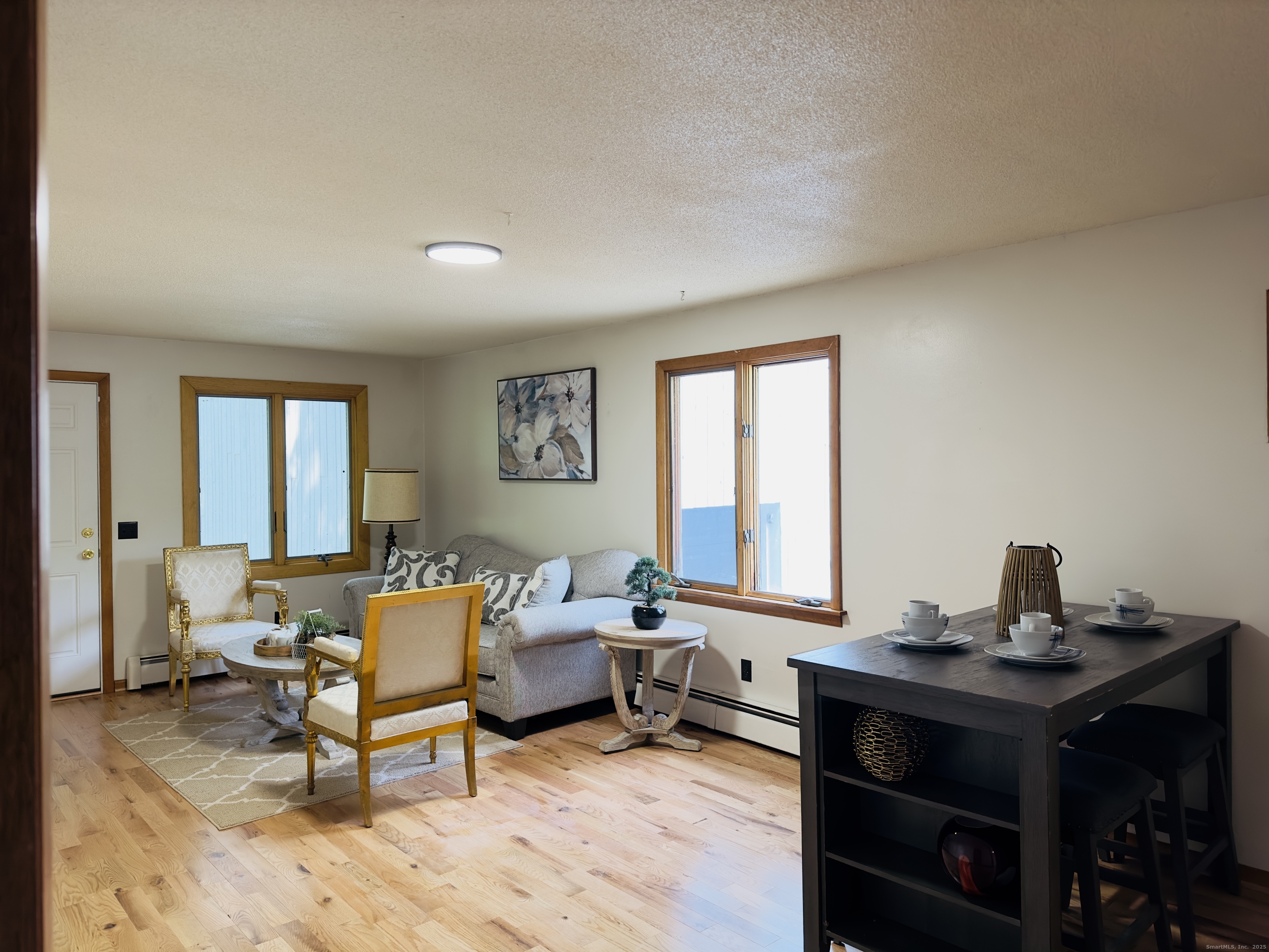 64 White Deer Rocks Road, Unit 5E Woodbury, CT 06798 - Photo 6 of 9 a living room with furniture and a window