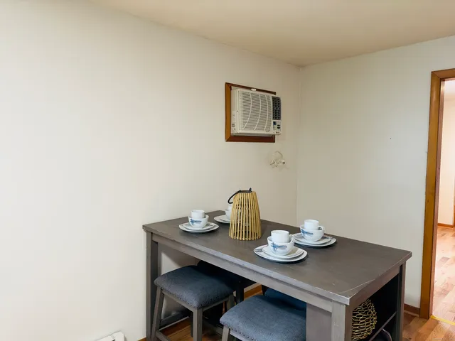 a view of a workspace with a table and chairs in it