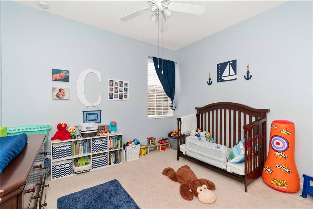 163 Southwest Walking Path Stuart, FL 34997 - Photo 15 of 37 a bedroom with furniture and a wooden floor