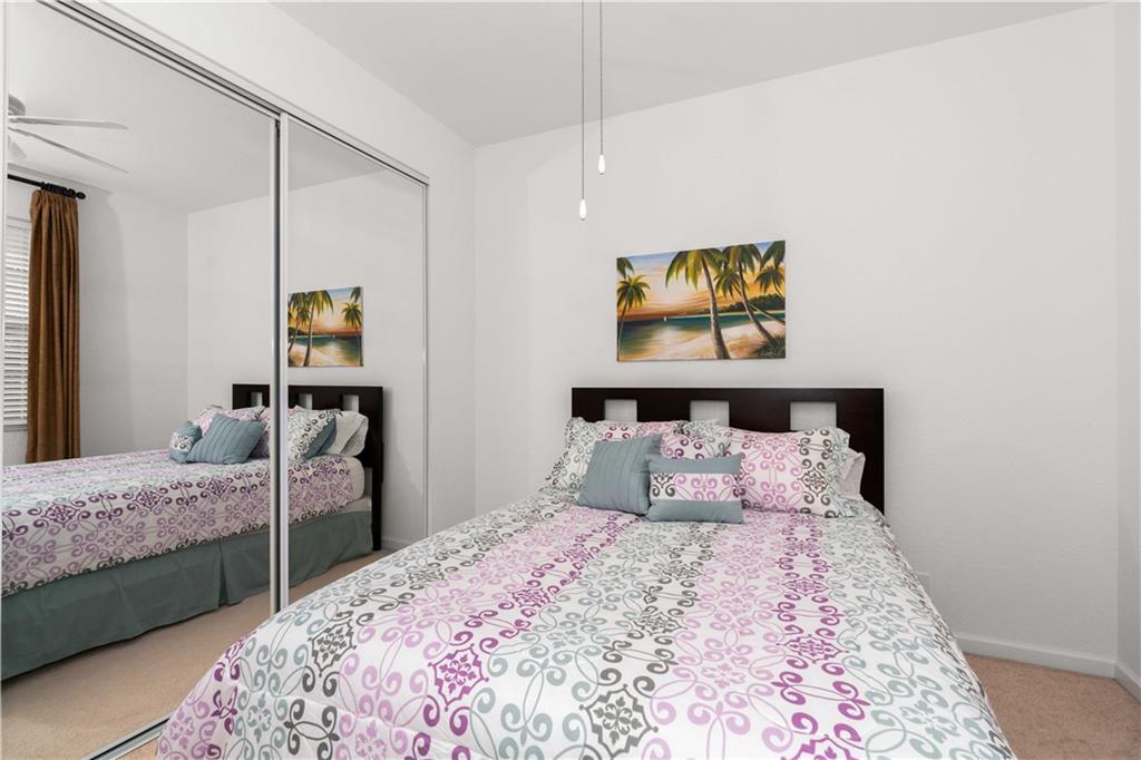 163 Southwest Walking Path Stuart, FL 34997 - Photo 19 of 37 a bedroom with a bed and a painting on the wall
