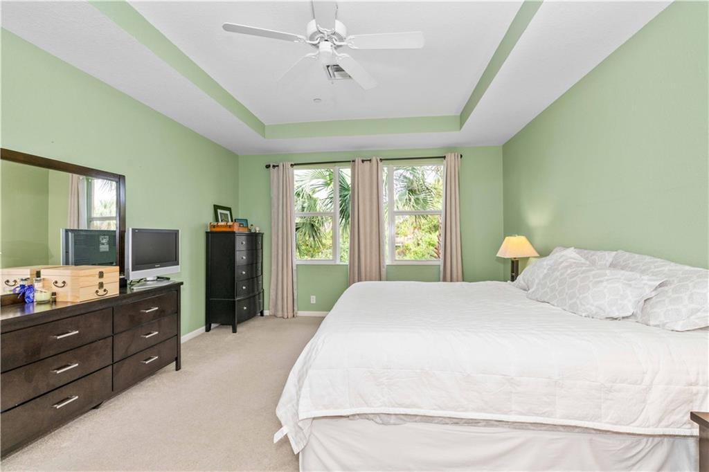 163 Southwest Walking Path Stuart, FL 34997 - Photo 21 of 37 a bedroom with a bed and a dresser